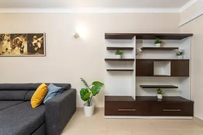a living room with a couch and shelves at Host Wise - Bright Lovely Flat - Balcony in Guia
