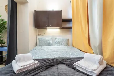 a small bedroom with a bed and a cabinet at Host Wise - Bright Lovely Flat - Balcony in Guia