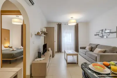 a living room with a couch and a tv at #251 Coronel Águas by Home Holidays in Albufeira