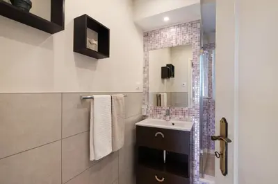 a bathroom with a sink and a mirror at Casa das Buganvilias in Loulé