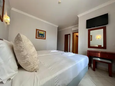 a white bed with a pillow on it in a room at Oceanview Bliss in Albufeira Retreat Over Oldtown in Albufeira