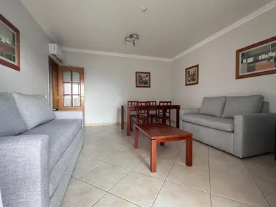 a living room with a couch and a table at Oceanview Bliss in Albufeira Retreat Over Oldtown in Albufeira
