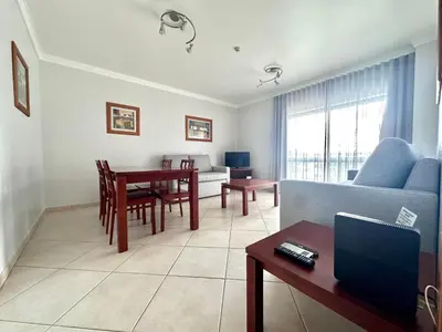 a living room with a couch and a table at Oceanview Bliss in Albufeira Retreat Over Oldtown in Albufeira