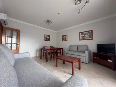 a living room with a couch and a table at Oceanview Bliss in Albufeira Retreat Over Oldtown in Albufeira
