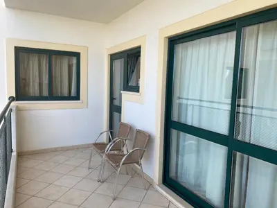 two chairs on the balcony of a house at Oceanview Bliss in Albufeira Retreat Over Oldtown in Albufeira