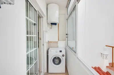 a laundry room with a washing machine and a window at Cozy Apt 5min Beach Ocean View AC Wi Fi in Albufeira