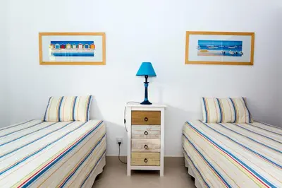 two beds sitting next to each other in a bedroom at The Albufeira Concierge - Villa Praia São Rafael in Albufeira