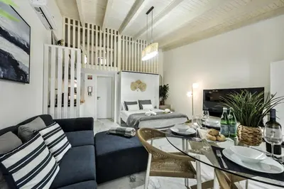 a living room with a couch and a table at Alcaçarias Suite 20 in Faro