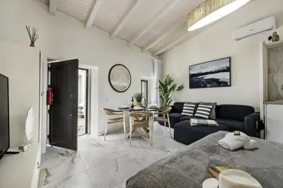 a living room with a couch and a table at Alcaçarias Suite 20 in Faro