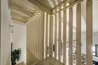 a hallway with wooden columns in a house at Alcaçarias Suite 20 in Faro