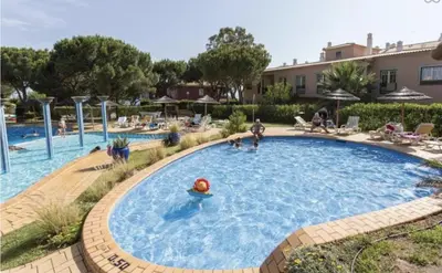 a pool at a resort with people playing in it at Host Wise - Wonderful Flats with Pool in Albufeira