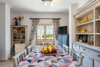 a kitchen with a table with a bowl of fruit on it at Host Wise - Wonderful Flats with Pool in Albufeira
