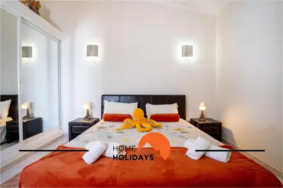 a bedroom with a large bed with a stuffed animal on it at #248 Villa Loureira 54 by Home Holidays in Albufeira