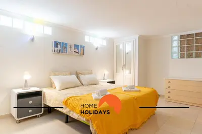 a bedroom with a bed with a home holidays sign on it at #248 Villa Loureira 54 by Home Holidays in Albufeira
