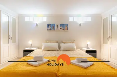 a bedroom with a large bed with a yellow blanket at #248 Villa Loureira 54 by Home Holidays in Albufeira