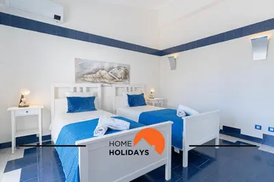 two beds in a room with a sign that says home holidays at #248 Villa Loureira 54 by Home Holidays in Albufeira