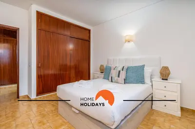 a bedroom with a bed with a wooden door at #252 Bartolomeu Dias 7 by Home Holidays in Albufeira