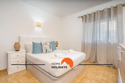 a bedroom with a bed with the words home huddles at #252 Bartolomeu Dias 7 by Home Holidays in Albufeira