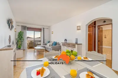 a kitchen and living room with a table with fruit on it at #252 Bartolomeu Dias 7 by Home Holidays in Albufeira