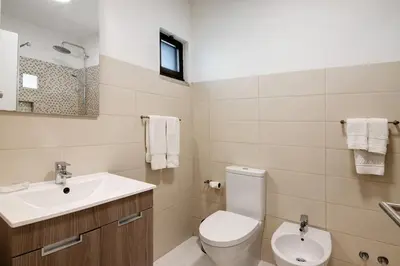 a bathroom with a toilet and a sink at Pear Tree Villa in Vale do Lobo