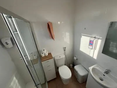 a small bathroom with a toilet and a sink at Castle House Loulé City Center in Loulé