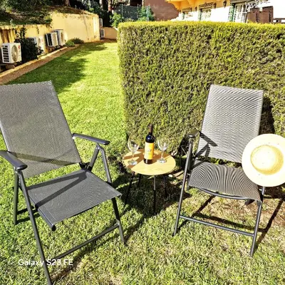 two chairs and a table with a bottle of wine at Moradia V2 - 200m da Praia da Oura - Santa Eulália in Albufeira