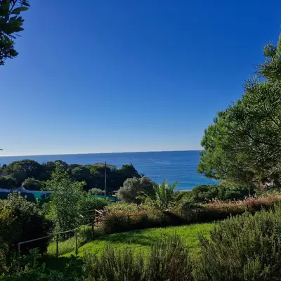 a view of the ocean from the garden at Moradia V2 - 200m da Praia da Oura - Santa Eulália in Albufeira