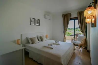 a bedroom with a bed with two towels on it at FLH Salgados Balcony Flat in Albufeira