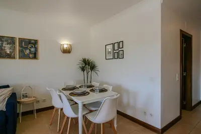 a white dining room with a white table and chairs at FLH Salgados Balcony Flat in Albufeira