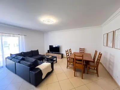 a living room with a couch and a table at Charming 3-Bedroom Villa with Pool in Albufeira in Albufeira