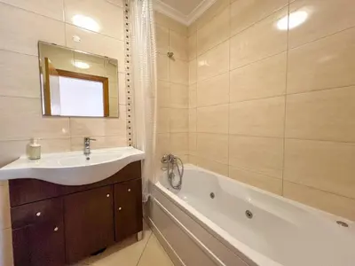 a bathroom with a sink and a bath tub at Charming 3-Bedroom Villa with Pool in Albufeira in Albufeira