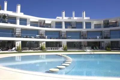 a large apartment building with a large swimming pool at Lakes 24 - Av Praia da Falésia in Quarteira