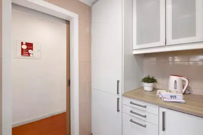 a kitchen with white cabinets and a door at Cool Motion 2149 in Albufeira