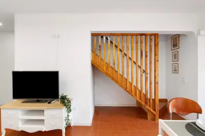 a living room with a couch and a flat screen tv at Cool Motion 2149 in Albufeira
