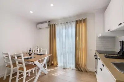 a living room with a dining table and a bed at Lovely And New Apartment In Oura in Albufeira