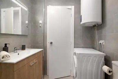 a bathroom with a sink and a toilet and a mirror at Lovely And New Apartment In Oura in Albufeira