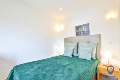a bedroom with a green bed with two pillows at Garrett by MTPhomes in Albufeira
