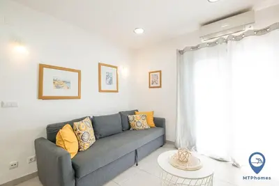 a living room with a couch and a table at Garrett by MTPhomes in Albufeira