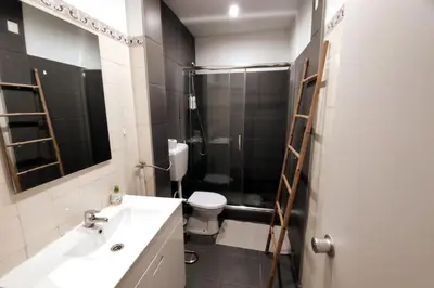 a bathroom with a sink and a toilet and a shower at Sea View Apartment Faro in Faro