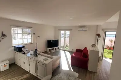 a living room with a red couch and a tv at Sea View Apartment Faro in Faro