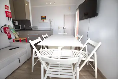 a white table and chairs in a living room at Marimar Sea View Apartment Faro in Faro