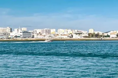 a large body of water with a city in the background at Marimar Sea View Apartment Faro in Faro