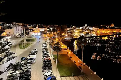 a bunch of cars parked in a parking lot at night at Marimar Sea View Apartment Faro in Faro