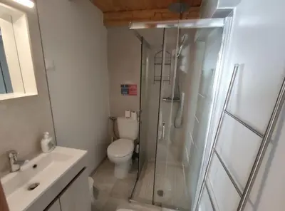 a bathroom with a shower and a toilet and a sink at Faro old town cosy typical house in Faro