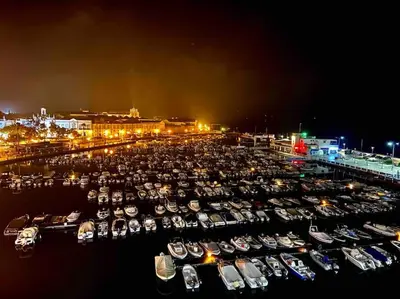a group of boats parked in a marina at night at Faro Ria Formosa Twin at city center in Faro