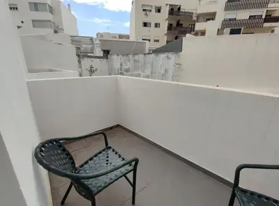 a chair sitting on top of a balcony at Faro Ria Formosa Twin at city center in Faro