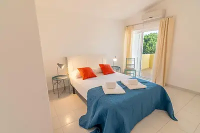 a bedroom with a bed with two towels on it at Vilamoura Beach Villa with Private Pool in Quarteira