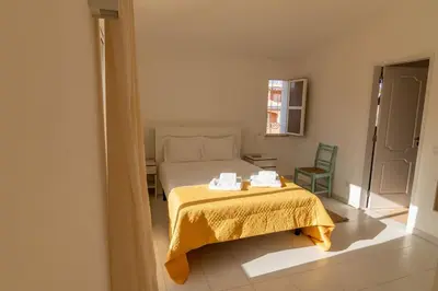 a bedroom with a bed and a table with towels on it at Vilamoura Beach Villa with Private Pool in Quarteira