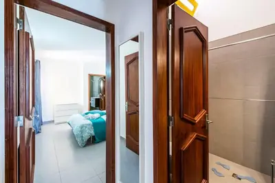 a door leading to a room with a bedroom at Vilamoura Beach Villa by nature with Olympic Pool in Quarteira