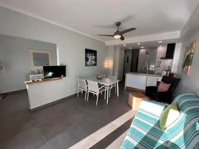a living room with a couch and a table at Carteia Mar by FHR frente Mar & piscina in Quarteira